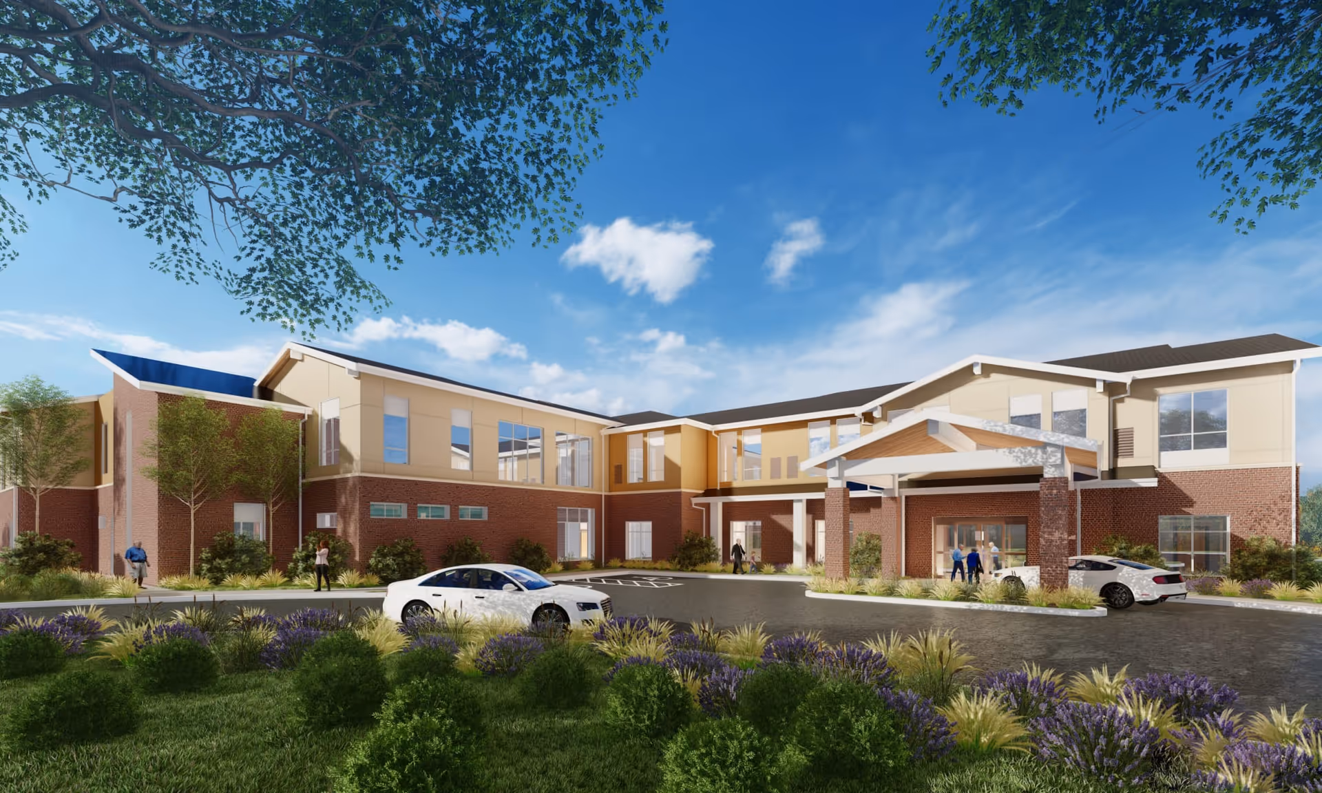 Exterior view of a two-story senior living facility building with a covered entrance, landscaped garden with bushes and flowers, and a few people walking near the entrance. Two white cars are parked in front of the building under a clear blue sky with some clouds.
