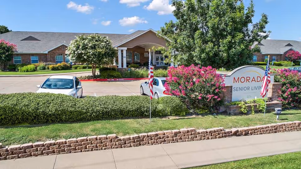 Exterior view of Morada Cedar Hill II senior living facility with sign and landscaping