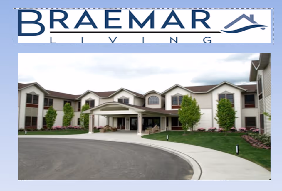 Exterior view of Braemar at Medford senior living building with a covered entrance, circular driveway, and landscaped lawn.