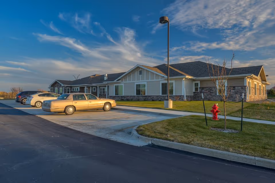 Exterior view of Northridge Village senior living facility with parked cars in front.