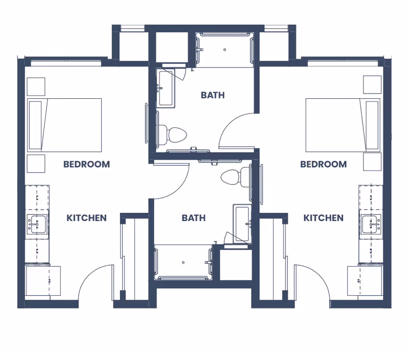 Architectural floor plan showing two mirrored one-bedroom units, each with a kitchen and central bathrooms.