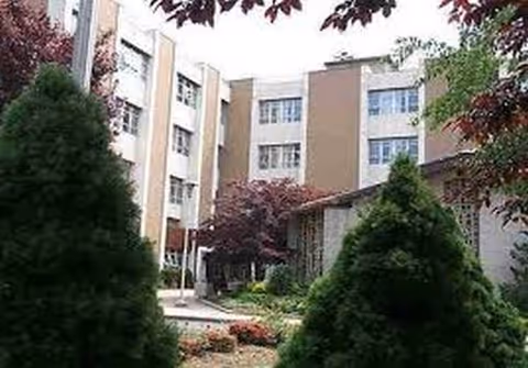 Exterior view of Saint Joseph's Residence showing a courtyard with trees and a walkway
