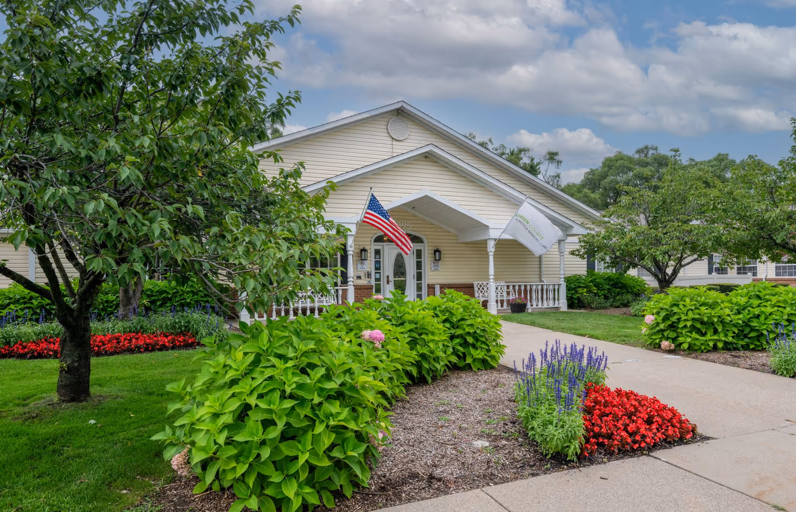 Exterior view of Arden Courts Sterling Heights with landscaped walkway and entrance