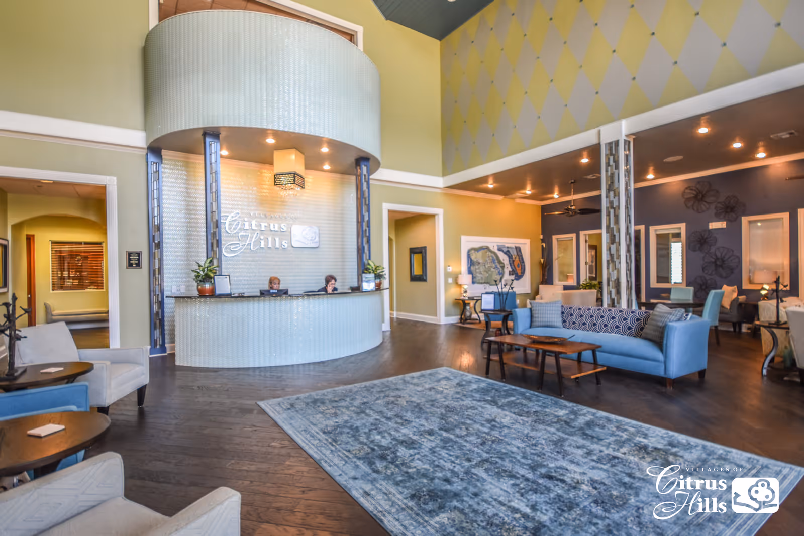 Bright, spacious lobby with a curved reception desk, seating areas, and decorative walls.