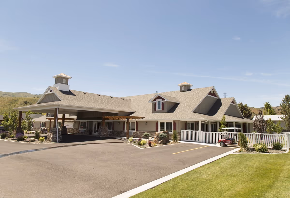 Exterior view of The Gables Memory Care of Pocatello building with driveway and landscaping.