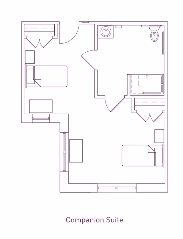 Architectural floor plan of a companion suite at Franklin Place Memory Care, showing two separate beds, two closets, a shared bathroom with a sink, toilet, and shower, and a common area with furniture.
