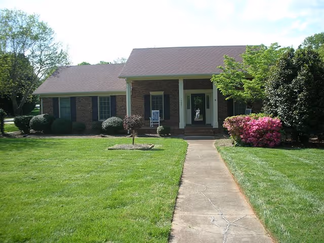 Grapperhall Family Care Home: single-story brick facility with front walkway and manicured lawn.