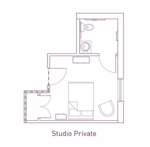 Architectural floor plan of a private studio apartment showing a main living and sleeping area with a bed, chair, and dresser, and a separate bathroom with a toilet and sink.