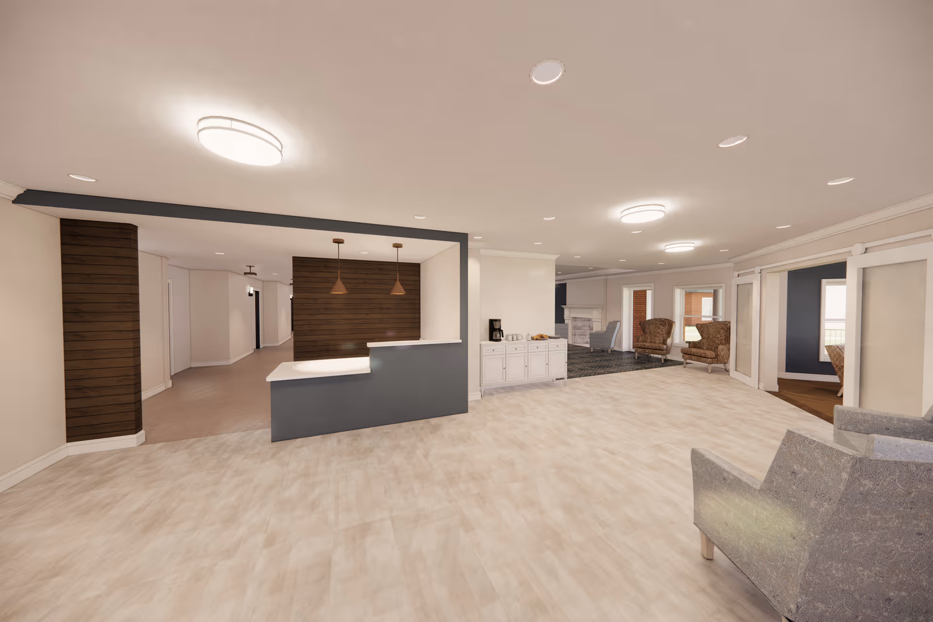 Open, well-lit senior living facility common area with a reception desk, seating, and wood-paneled accents.
