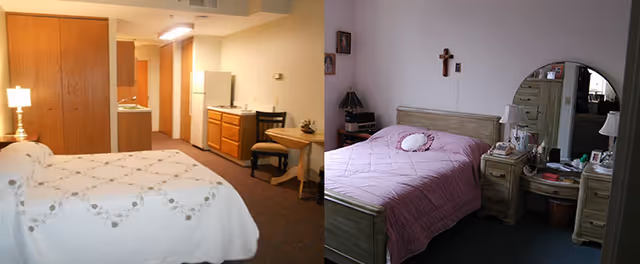 Two side-by-side images of bedrooms in a senior living facility. The left image shows a room with a bed covered in a white quilt, a wooden closet, a small kitchenette with a refrigerator, sink, and cabinets, and a small table with chairs. The right image shows a bedroom with a bed covered in a pink quilt, a wooden dresser with a round mirror, a nightstand with a lamp, and religious decorations on the wall.