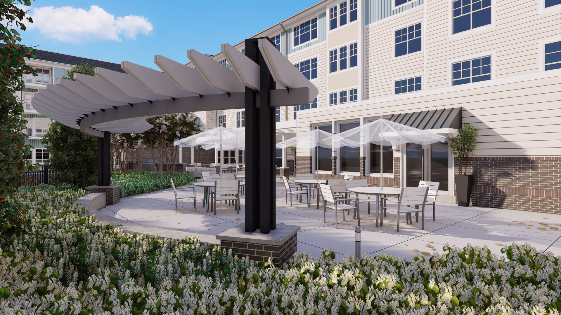 Outdoor patio area at Acclaim at Greenbrier featuring a curved pergola, multiple round tables with chairs, and white umbrellas. The patio is surrounded by greenery and flowers, with a multi-story building in the background under a partly cloudy sky.