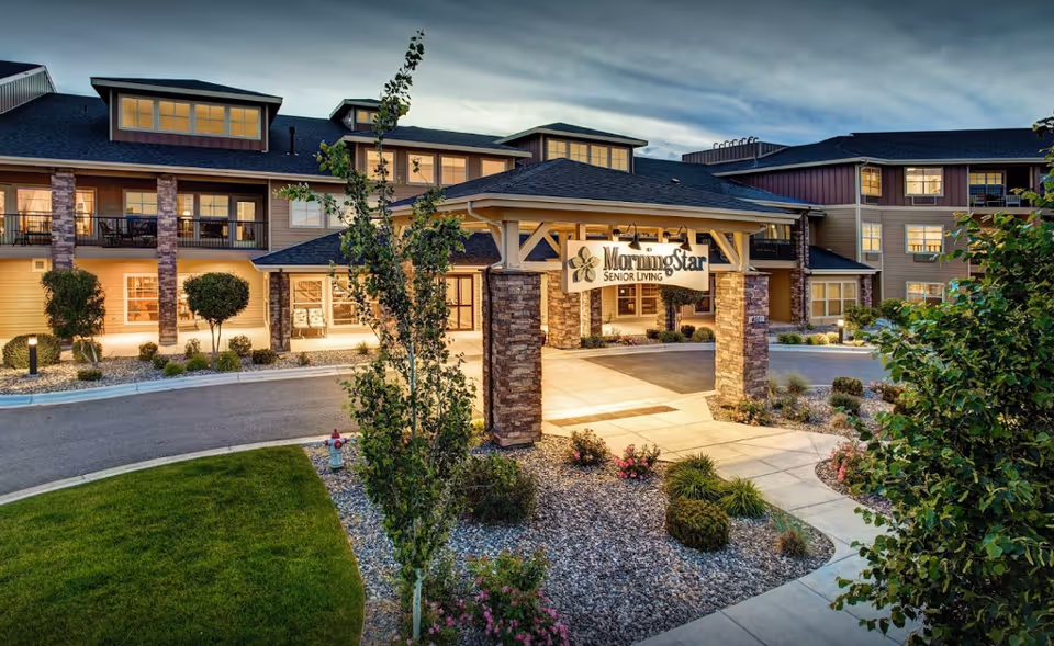 Exterior view of MorningStar Senior Living entrance with sign and landscaped grounds.