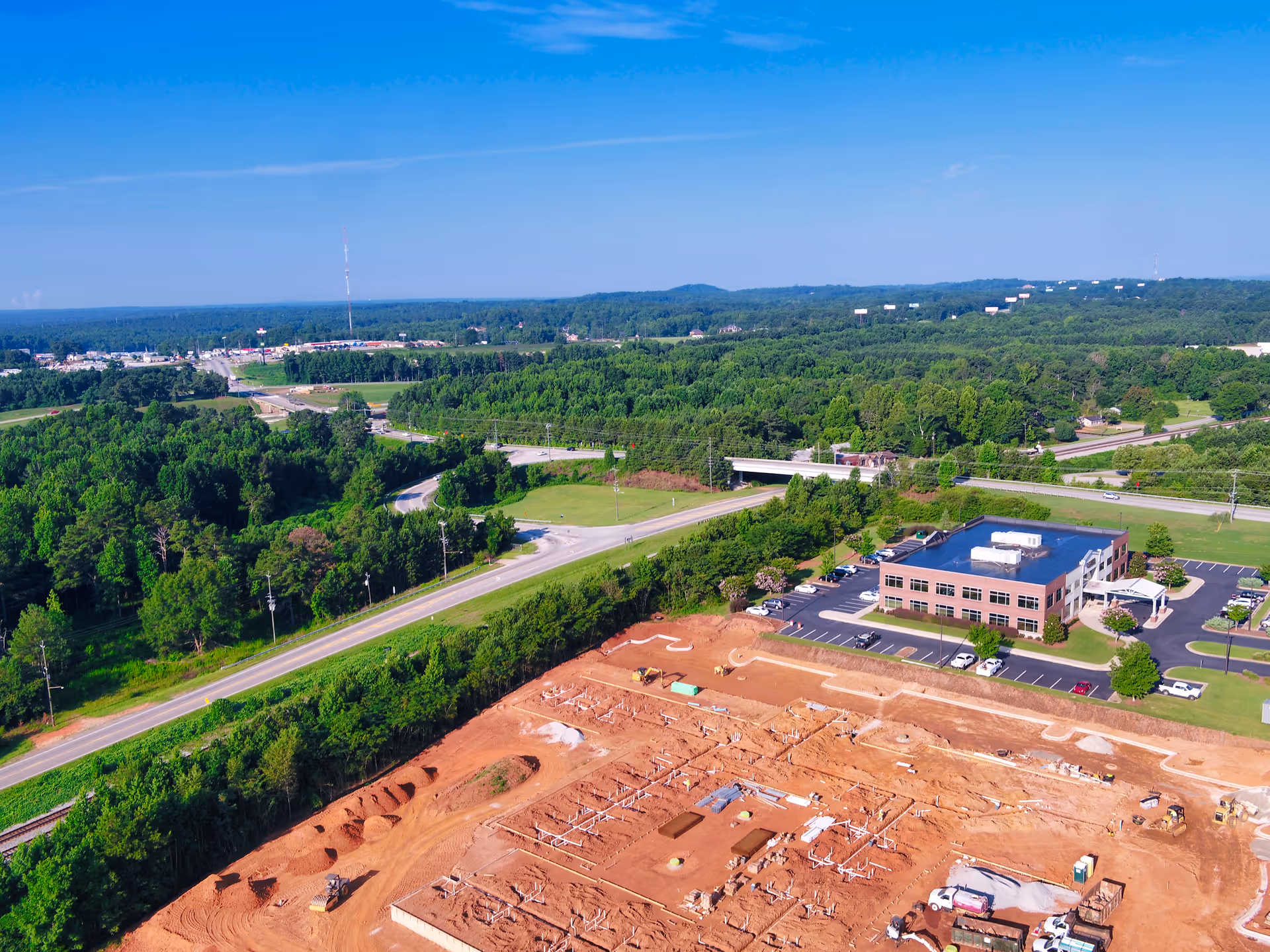 Aerial view of The Birches at Villa Rica with ongoing construction, greenery, and roads nearby.