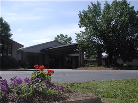 Front exterior view of Grand Villa Assisted Living at Winston with entrance canopy and landscaping
