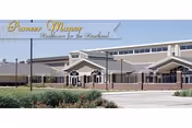 Front exterior view of Pioneer Manor building with entrance and landscaped surroundings.