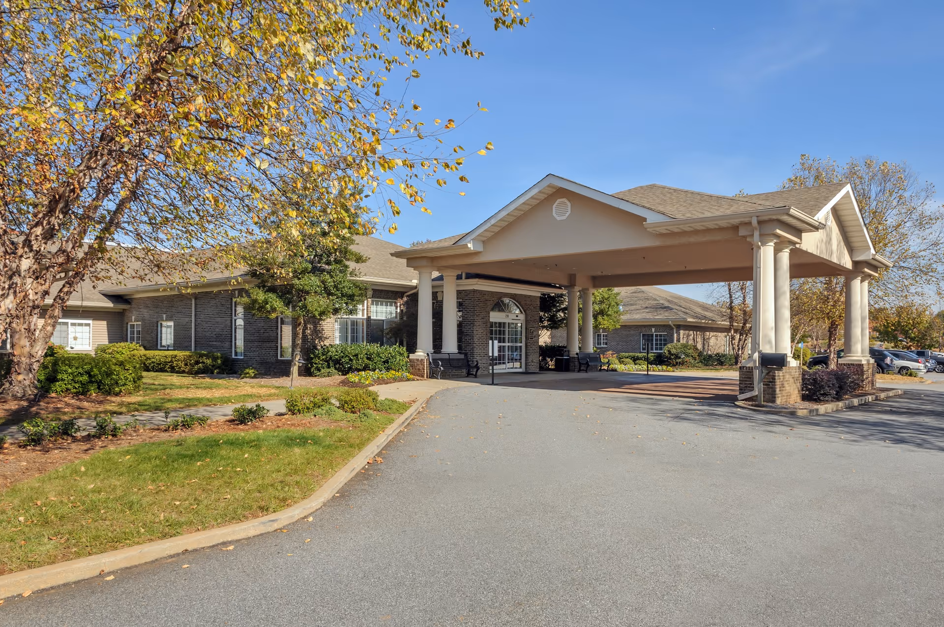 Exterior view of the Life Care Center of Lawrenceville entrance with a canopy and landscaped area.