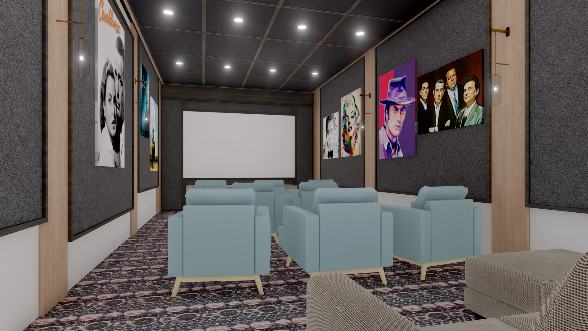 A small theater room with light blue armchairs arranged in rows facing a large blank screen. The walls are decorated with framed movie posters and dark acoustic panels. The ceiling has recessed lighting, and the floor is covered with a patterned carpet.