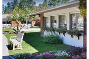 Exterior view of Complete Care at Fox Hill with a bench and manicured lawn.