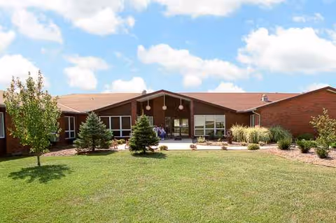 Front view of Life Care Center of Seneca with landscaping and blue sky.
