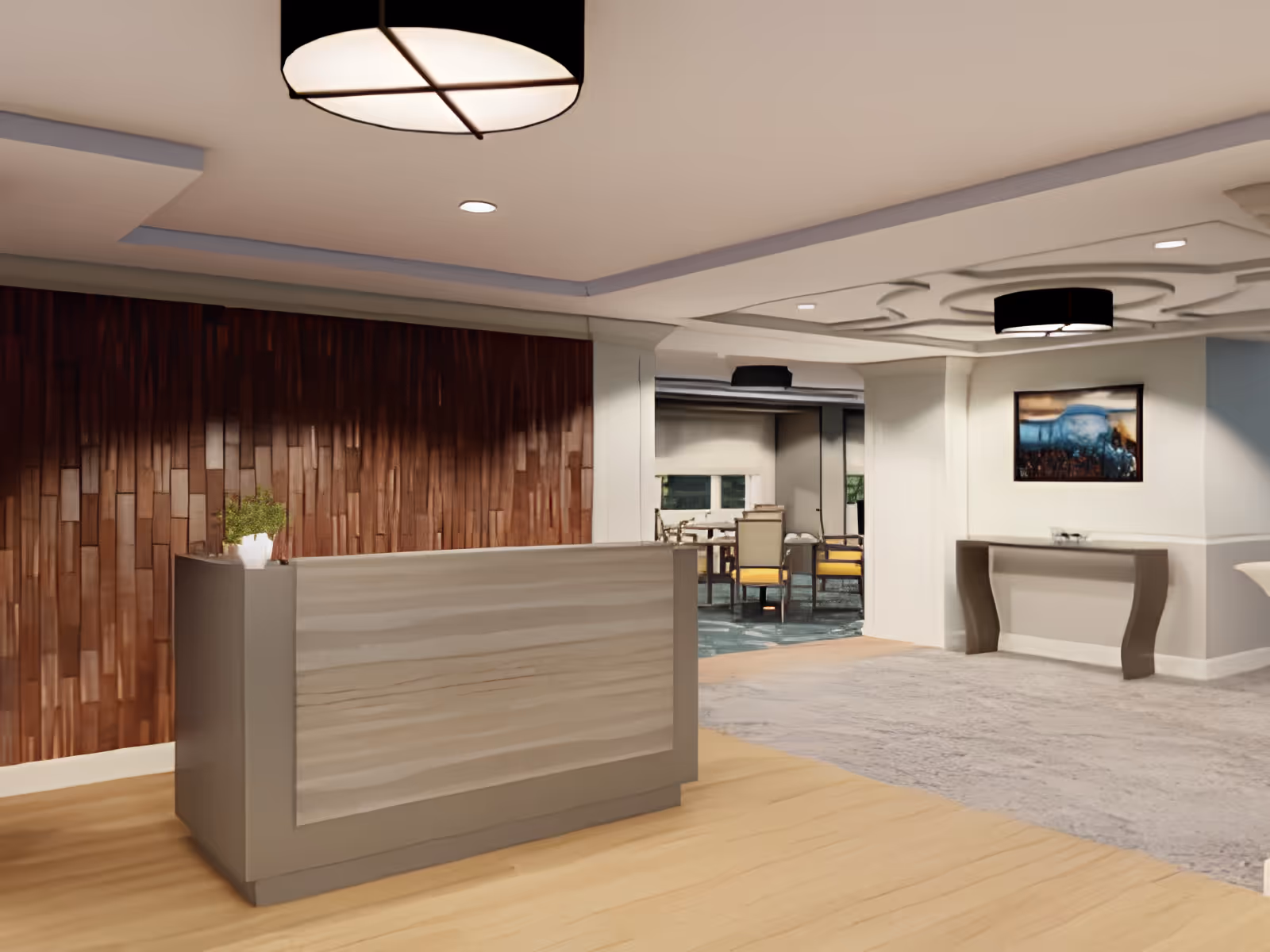 Modern reception lobby with a front desk, wood accent wall, seating visible in the background, and overhead lighting.