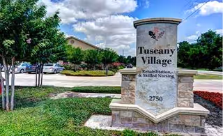 Stone sign for Tuscany Village Skilled Nursing and Rehabilitation with manicured landscaping and parking