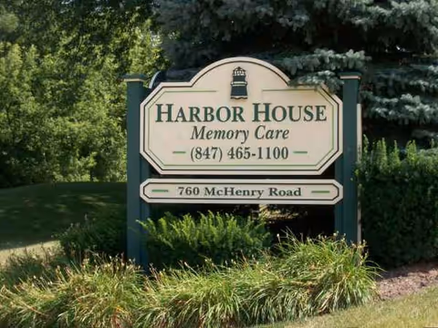 Outdoor sign reading Harbor House Memory Care with address and phone number.