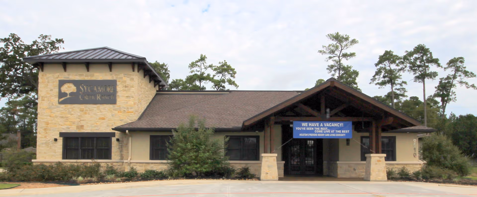 Front view of Sycamore Creek Ranch at Cypresswood, stone facade and entrance.