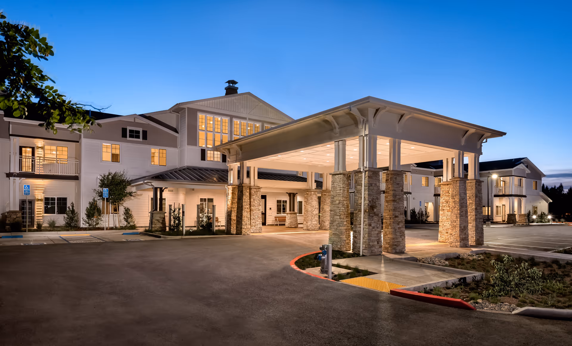 Exterior view of Clearwater at Sonoma Hills entrance with canopy, pillars, and parking lot.