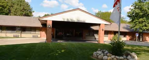 Front view of East Lake Nursing and Rehabilitation Center entrance with brick facade.