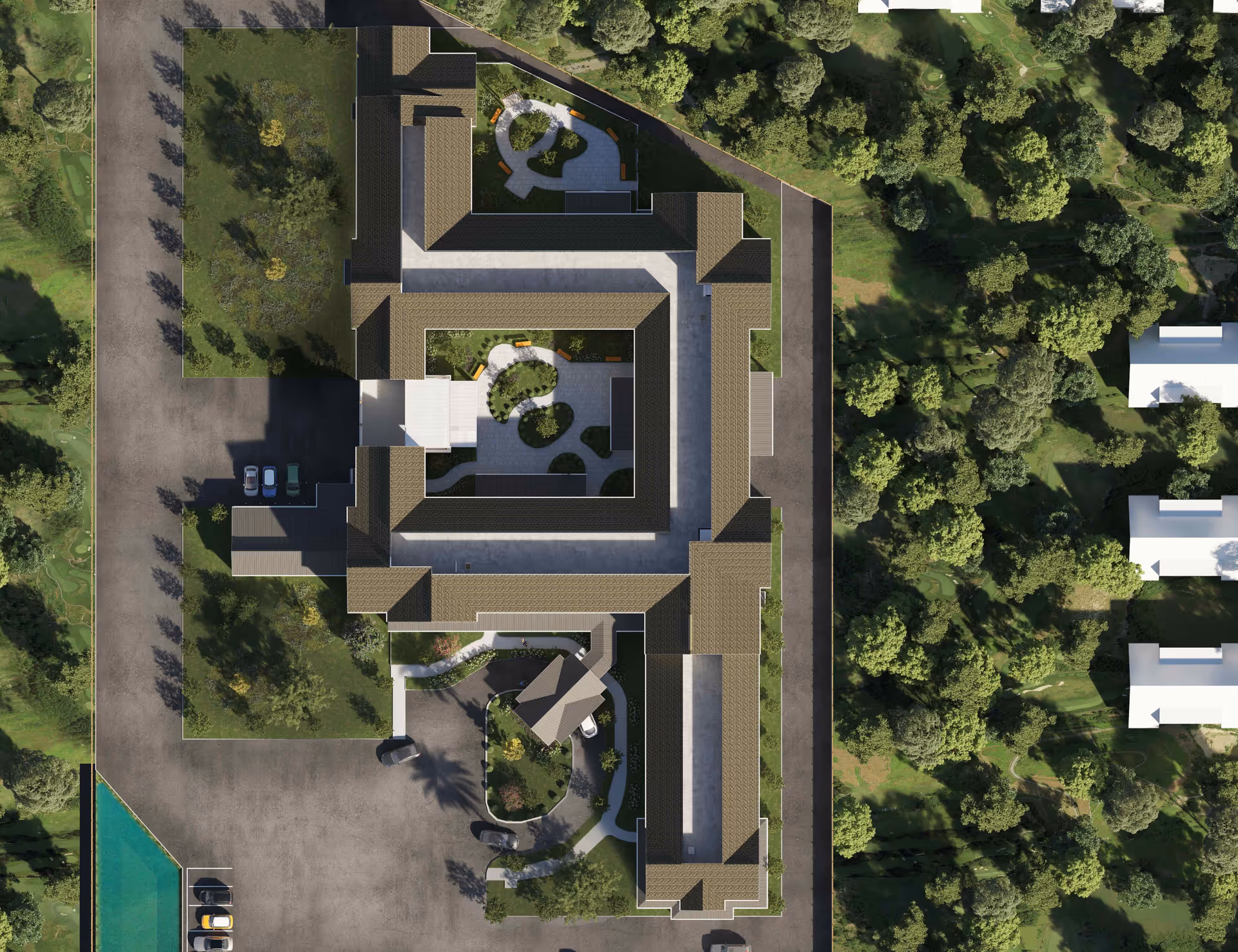 Aerial view of Ridgewood Senior Living at Historic Smithville showing the building layout with a central courtyard, surrounding greenery, parking areas, and nearby trees.