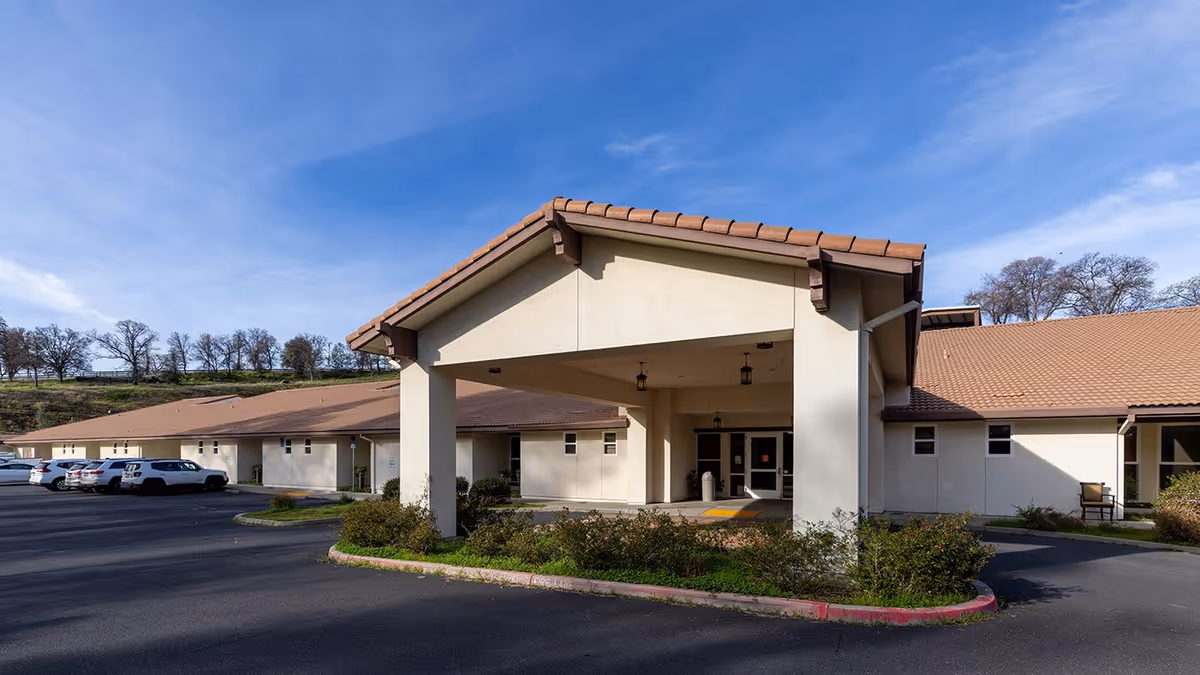 Front view of Golden Sonora Care Center showing a covered entrance and surrounding parking.