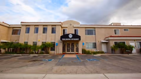 Exterior view of Park Regency Retirement Center front entrance with parking lot and landscaping