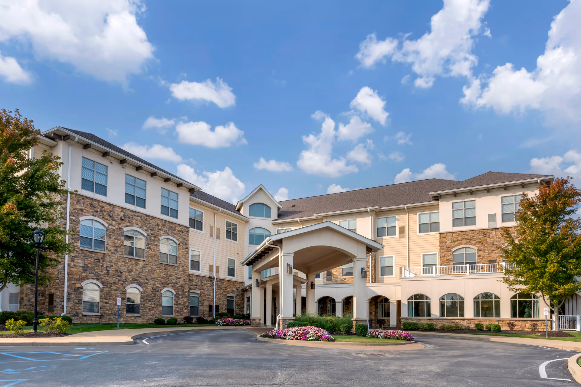 Wide view of Brookdale West County senior living facility exterior with entrance canopy and landscaped grounds.