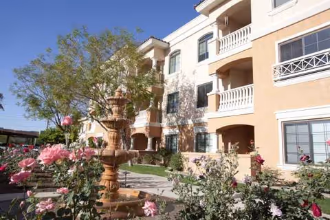 Exterior view of The Terraces of Phoenix showing a fountain and blooming roses.