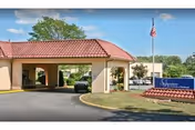 Front entrance of Signature HealthCARE of Cleveland with a covered drive and flag