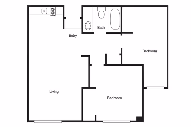 Floor plan of a two-bedroom apartment with a living area, kitchen, bathroom, and entry. The layout shows the placement of rooms and fixtures including a bathtub, toilet, sink, and kitchen appliances.