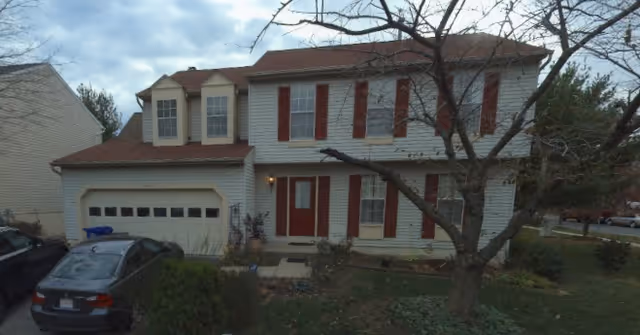 Exterior view of Harmony Rose Senior Care Living building with garage.