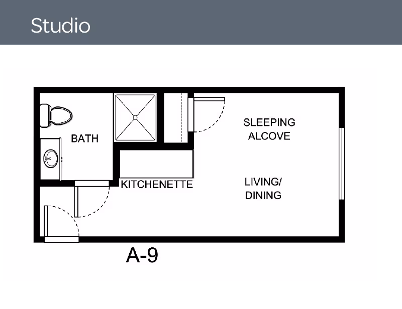 Floor plan of a studio apartment labeled A-9 showing a bath with toilet and sink, a kitchenette, a sleeping alcove, and a combined living/dining area.