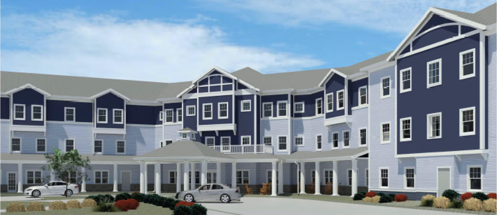Exterior view of a large, three-story assisted living facility building with a covered entrance, multiple windows, and landscaped bushes and trees. Two cars are parked near the entrance under a clear blue sky.