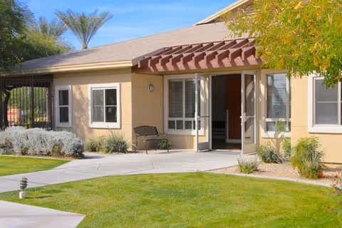 Sunshine Circle Assisted Living Enclave building front with open entrance and landscaped walkway.