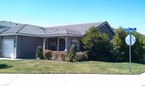 Single-story house-style building with a front porch and well-kept lawn.