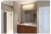 Bathroom showing a wooden vanity with marble countertop and mirror, overhead lighting, and a walk-in shower.