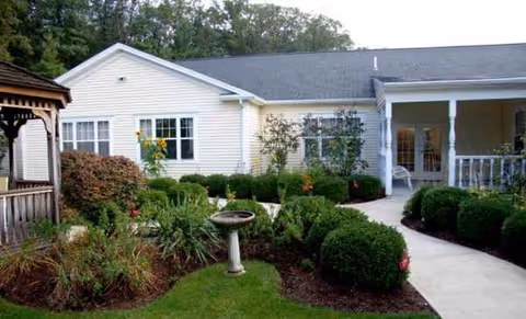 Front exterior of The Atrium at Veronica Drive with landscaped garden and walkway.