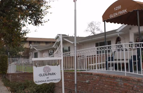 Exterior view of Glen Park at Glendale - Boynton with white railings and sign