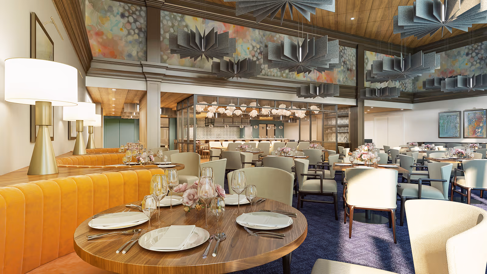 A spacious, elegant dining room with round wooden tables set with white plates, glassware, and floral centerpieces. The room features mustard yellow upholstered bench seating along one side, cream-colored chairs, modern pendant lighting, and decorative wall art. The ceiling has wooden paneling and unique geometric light fixtures.