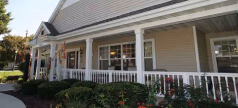 Exterior view of Brookdale Sussex with a covered porch and shrubs.