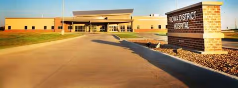 Exterior view of Kiowa Hospital District Manor with driveway and main entrance.