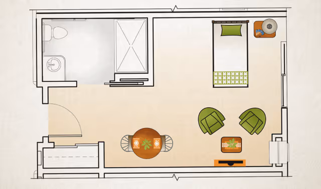 Floor plan of a small living space featuring a bathroom with a toilet, sink, and shower in the upper left corner. The main room includes a single bed with a pillow and blanket, a round dining table with two chairs, two green armchairs facing a small table with a plant, and a TV stand. There is a window on the right wall and a door on the bottom left.