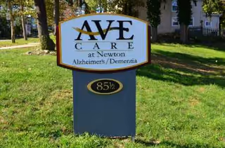Ave Care at Newton sign on a grassy front lawn beside a building