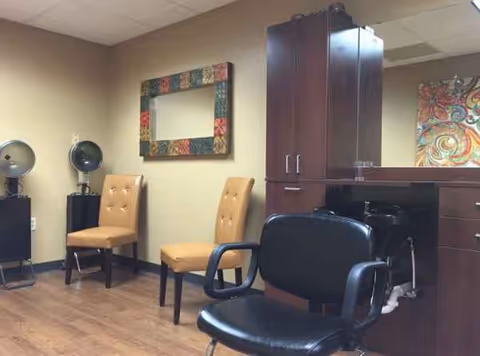 Interior salon area in a senior care facility with chairs, mirrors, and cabinetry